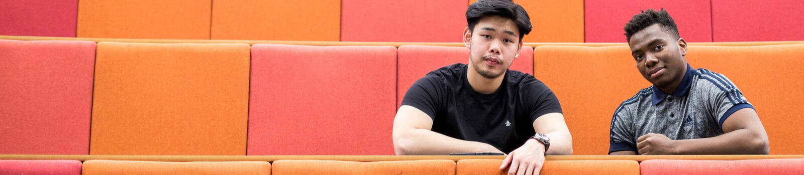 Two students in a lecture hall