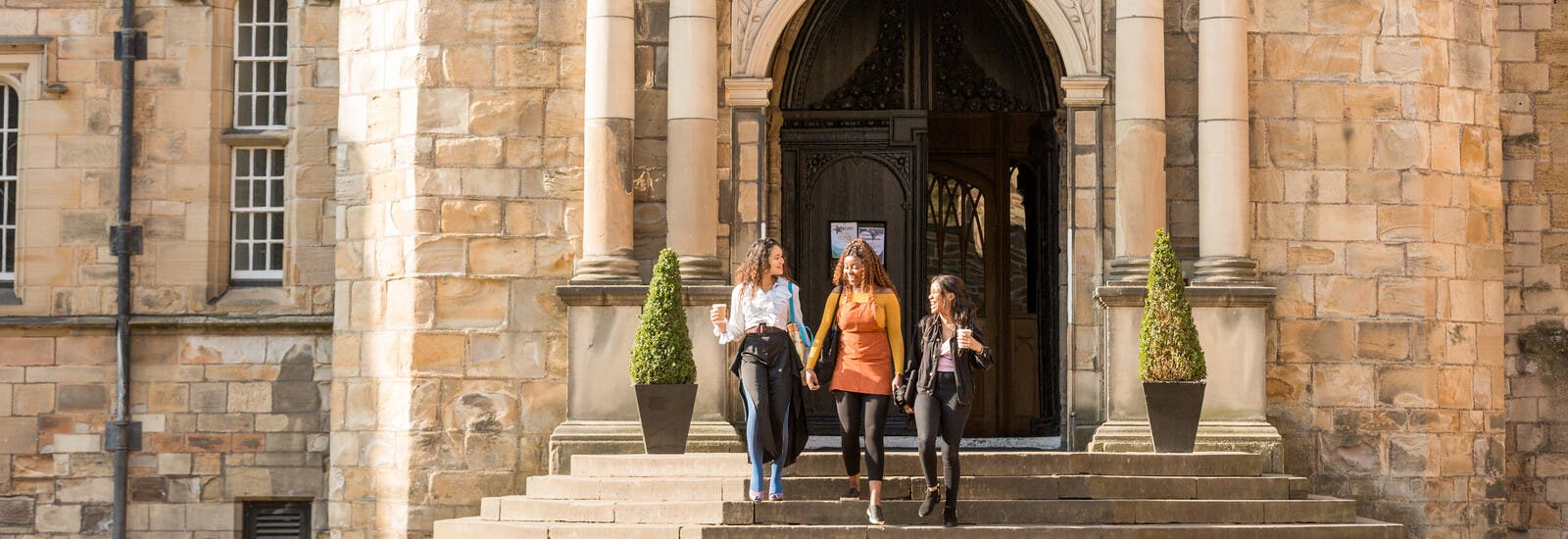 Durham students walking down steps outside campus