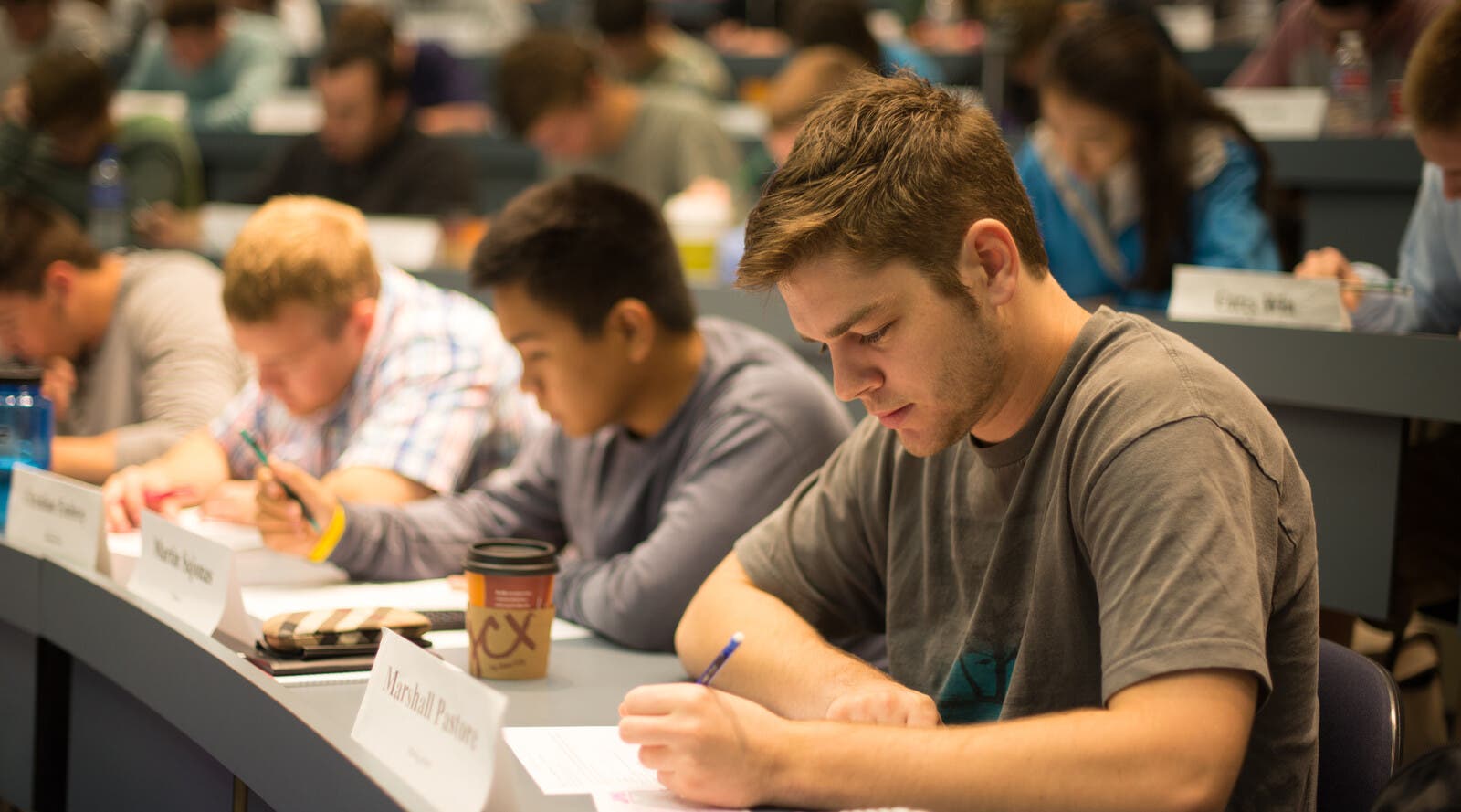 Students writing in lecture hall