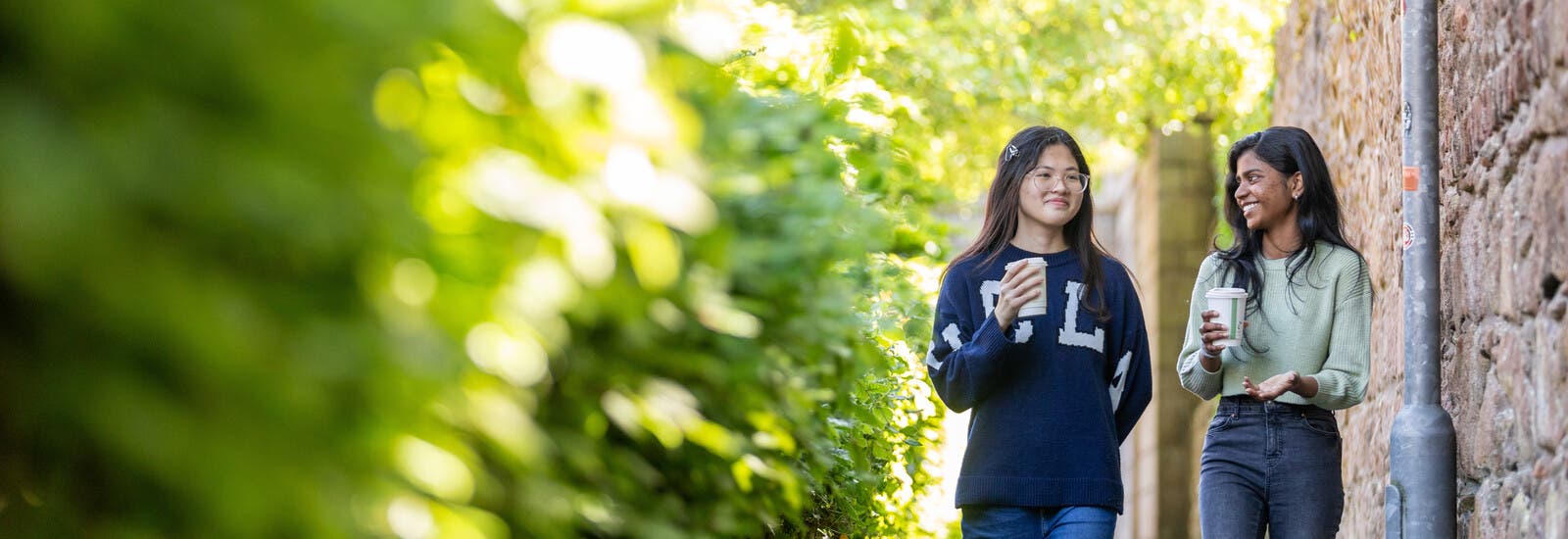 Two students talking and walking