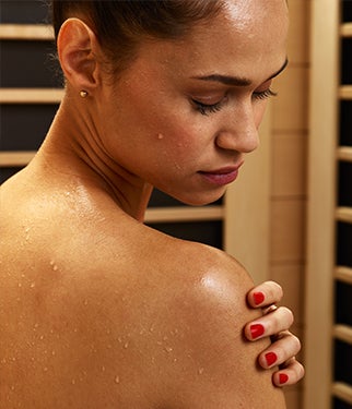 Woman sweating in a sauna