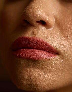 Closeup on woman's sweating face