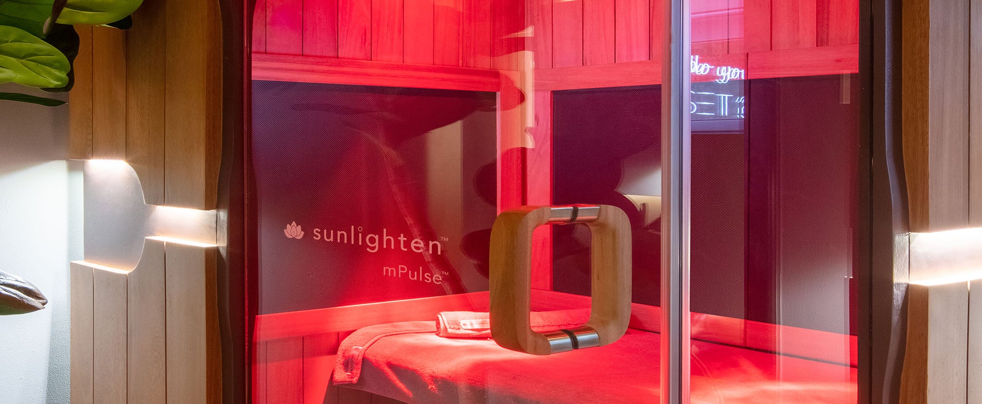 Sunlighten mPulse sauna with red chromotherapy lights on