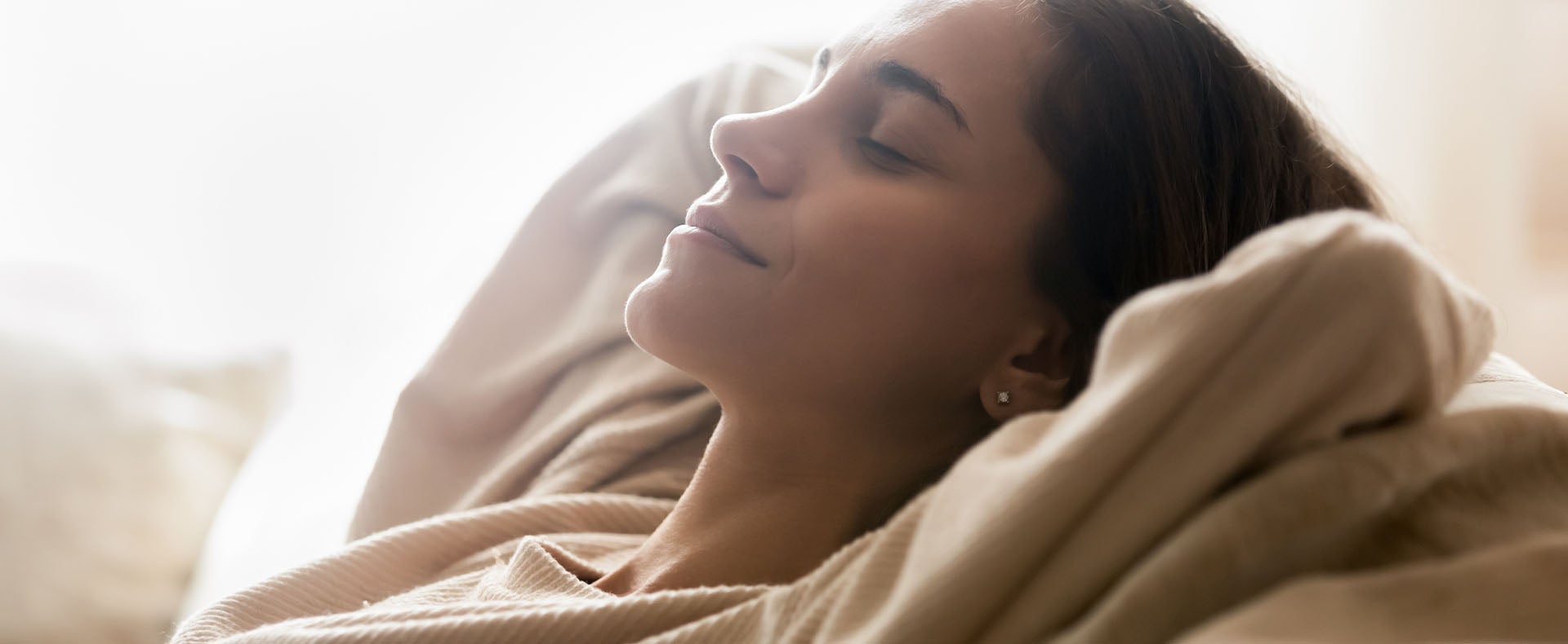 Woman happily relaxing with her eyes closed