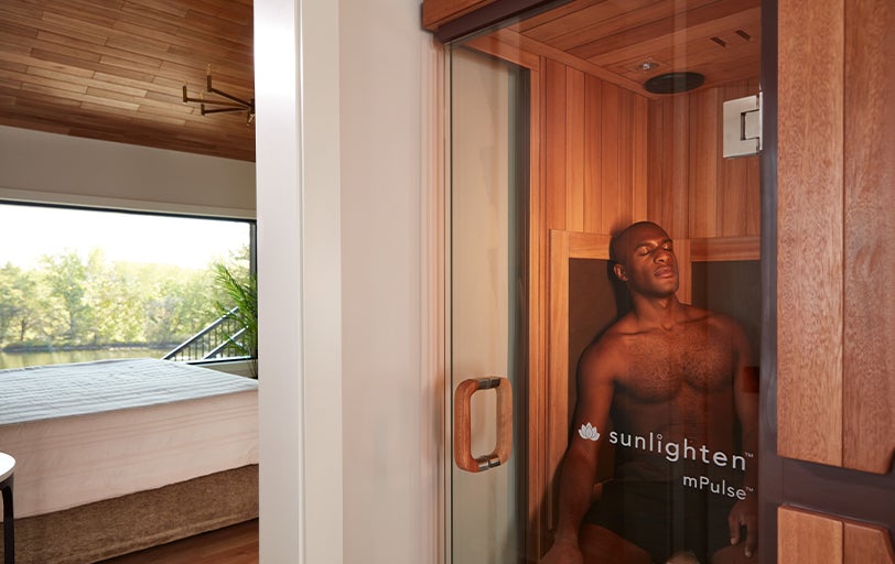 Man relaxing in Sunlighten mPulse Believe sauna.