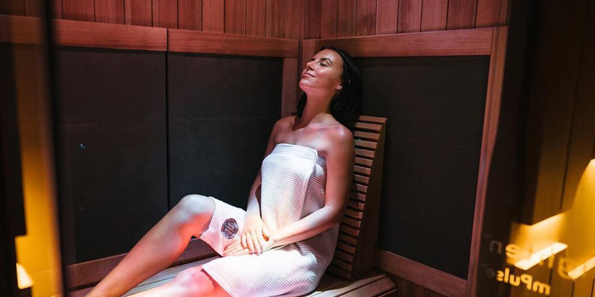 Woman Relaxing in an Infrared Sauna