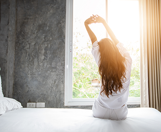 Woman stretching in the morning sun