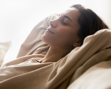 Woman happily relaxing with her eyes closed