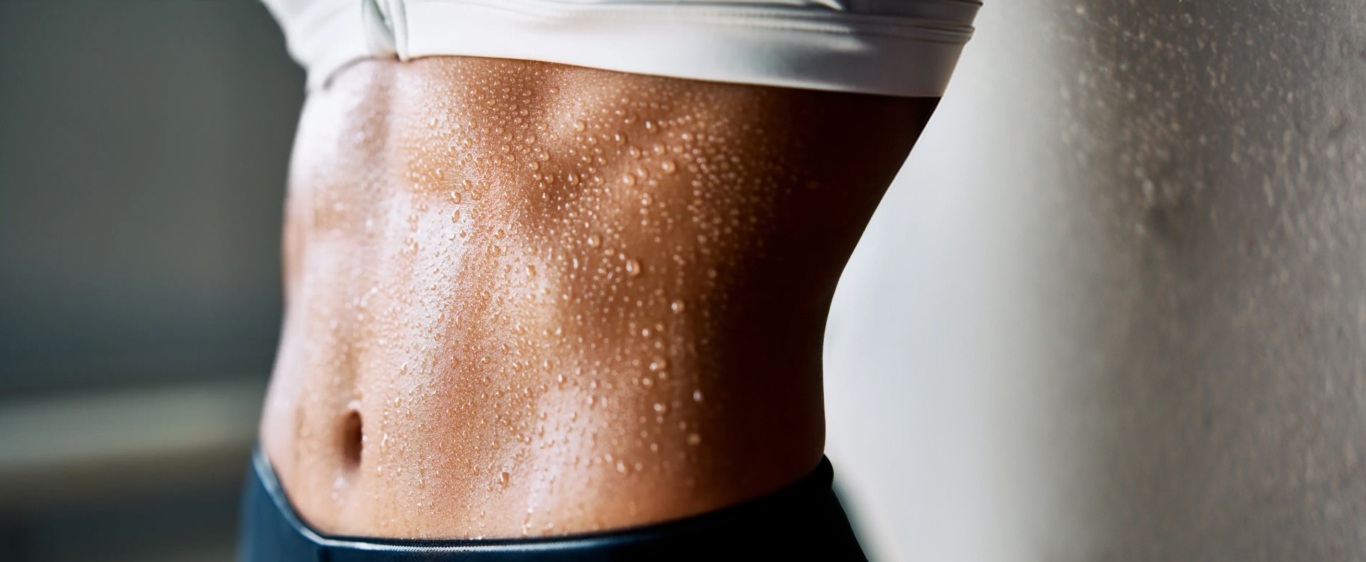 Athletic female's sweating stomach