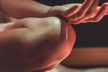 knees and hands in infrared sauna