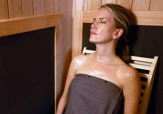 Woman relaxing in sauna