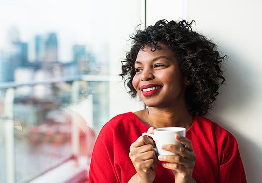 Woman smiling while looking out the window