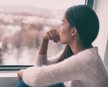 Girl sitting down looking out the window