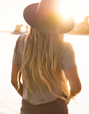 Woman wearing hat standing in the sun