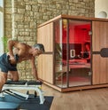 Woman in mPulse Empower. Man exercising outside sauna.