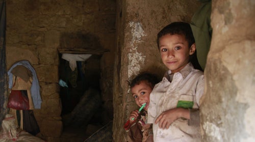 Children stand in their dilapidated house in Yemen 