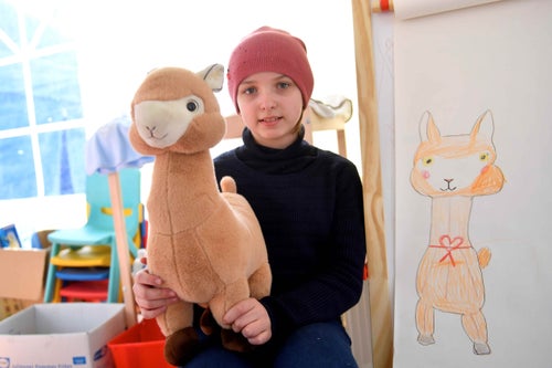 In Romania, 2022, 11-year-old Ukrainian Anastasia poses for a photograph with her new toy while in the UNICEF-supported Blue Dot centre, where her and her family receive emergency support after escaping escalating violence. © UNICEF/UN0627036/Nicodim 