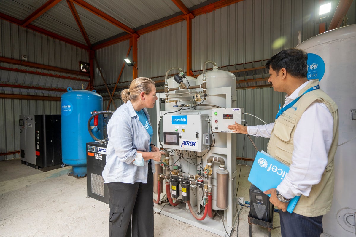 People looking at oxygen cylinders