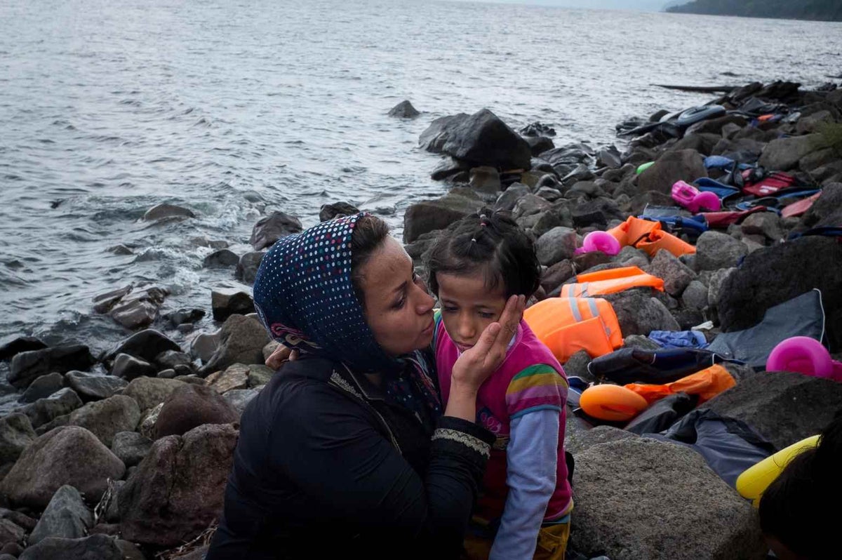 Fatime Zadeh kisses her daughter Zarah on the shores near the town of Mithymna, Lesbos, in 2015. Both are refugees from Afghanistan.