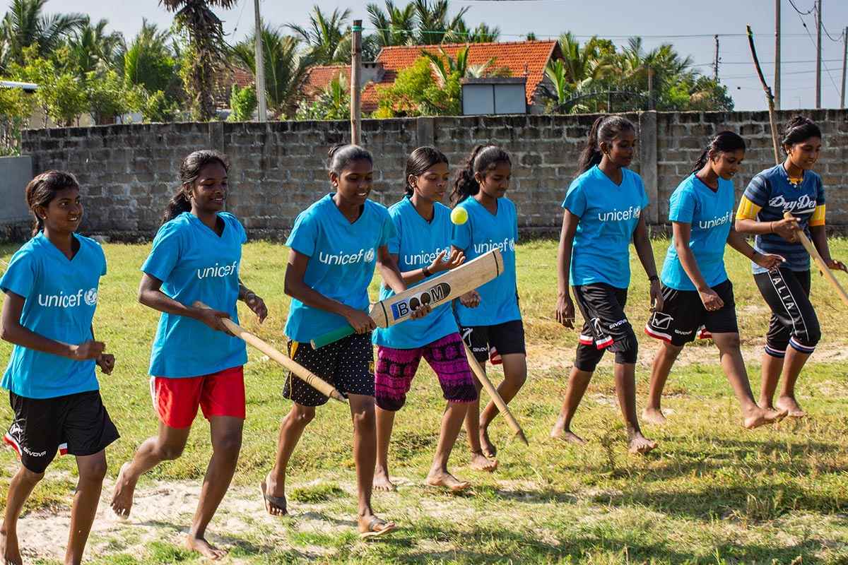 A Sri Lankan girls cricket team warming up ahead of a training session 