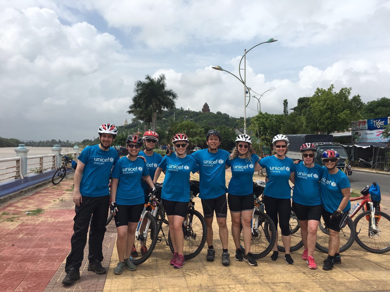 A group of people wearing bike helmets and UNICEF t-shirts