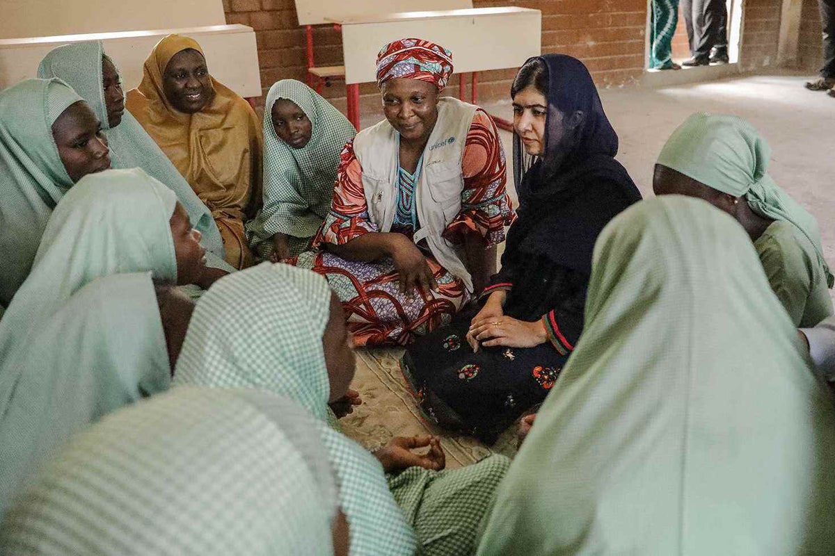 Malala talks to a group of women