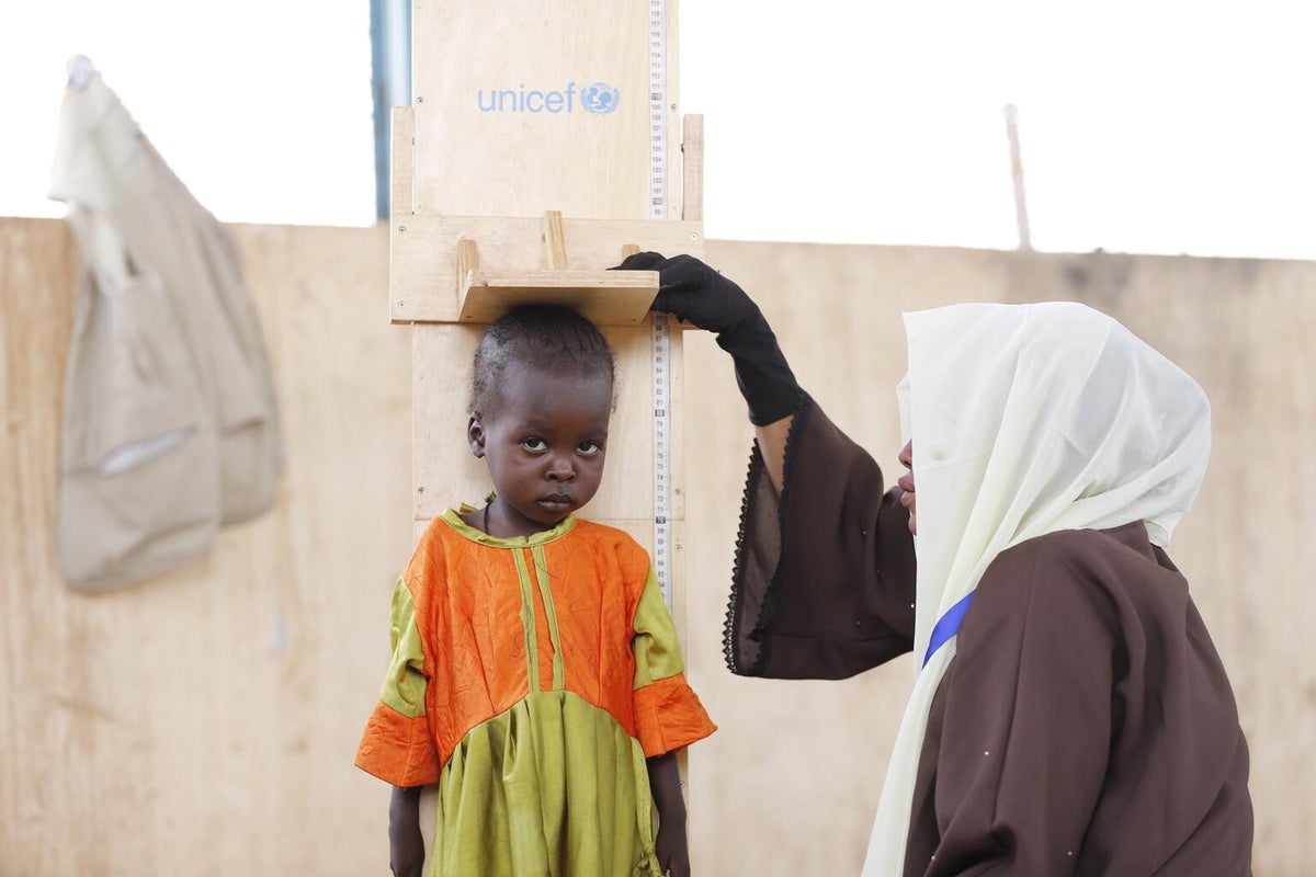 A little girl is being screened for malnutrition by a UNICEF-supported health worker in North Darfur.