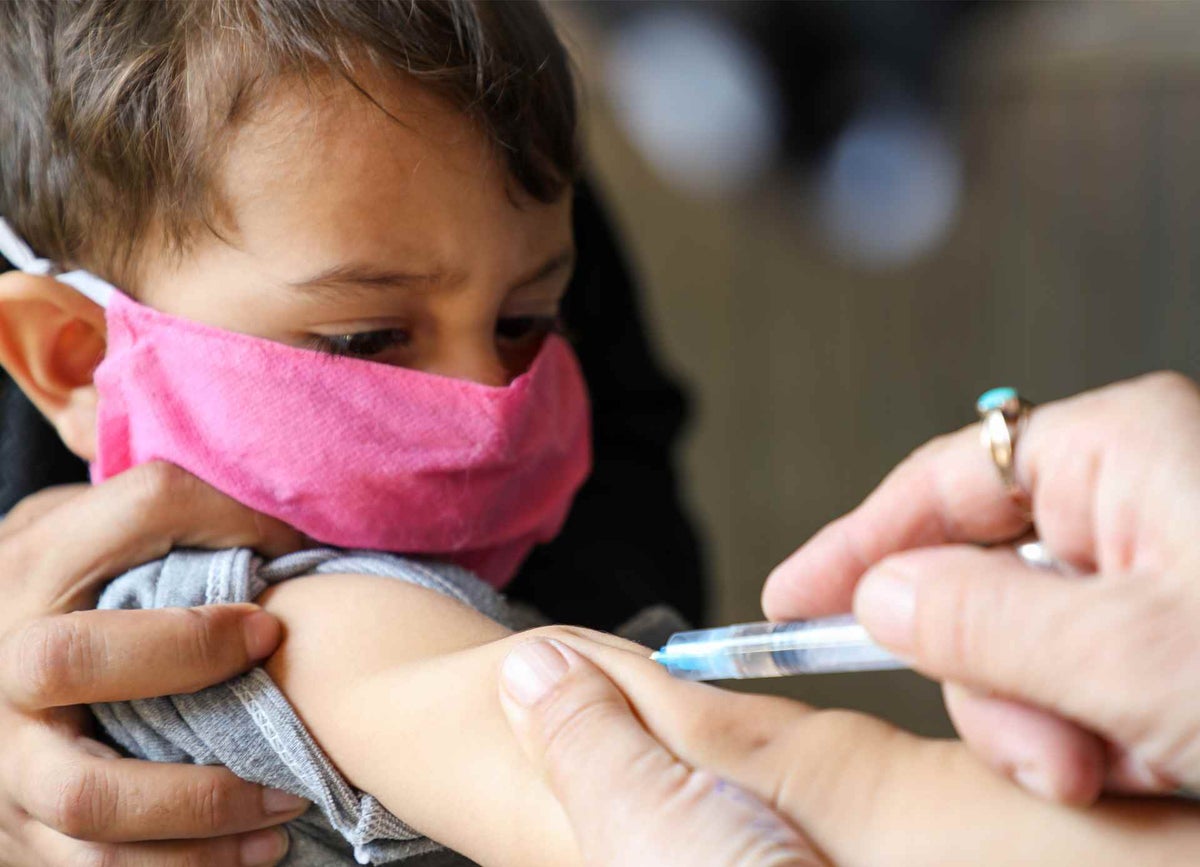 Musbashir, two, wears a home-made mask and receives his measles vaccine at a hospital in Kabul, Afghanistan’s capital.