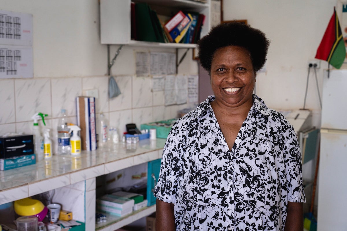 A nurse standing in front of equipment in a hospital room.