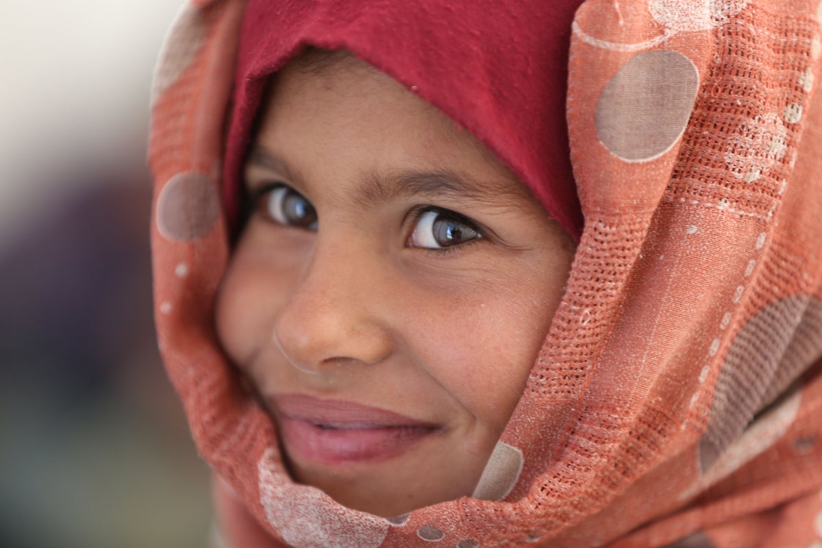 Close up of Syrian girl wearing peach coloured headscarf