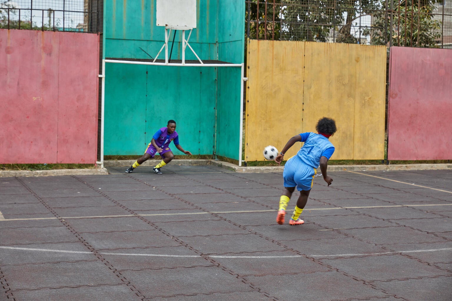 Kenyan sister's playing soccer