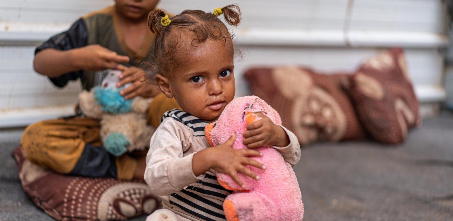 Young girl with soft toy donated by UNICEF