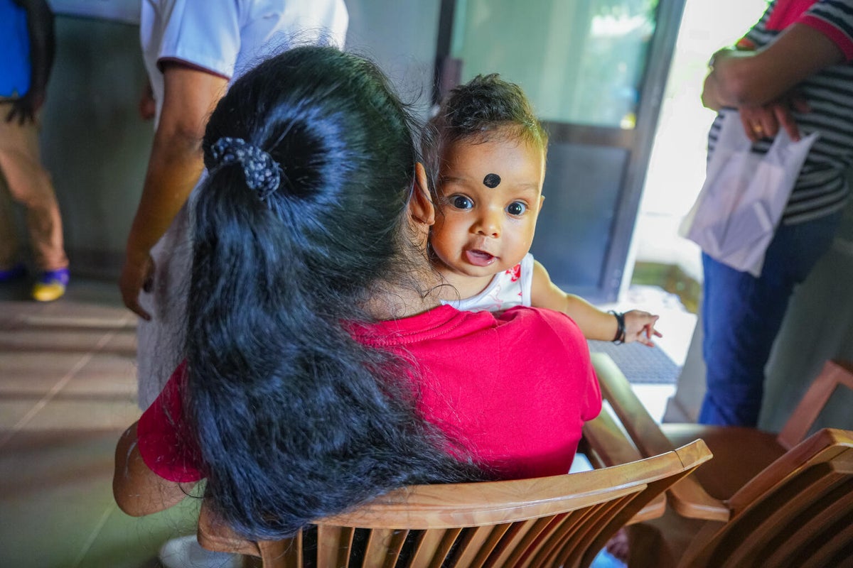 A mother holds her newborn baby