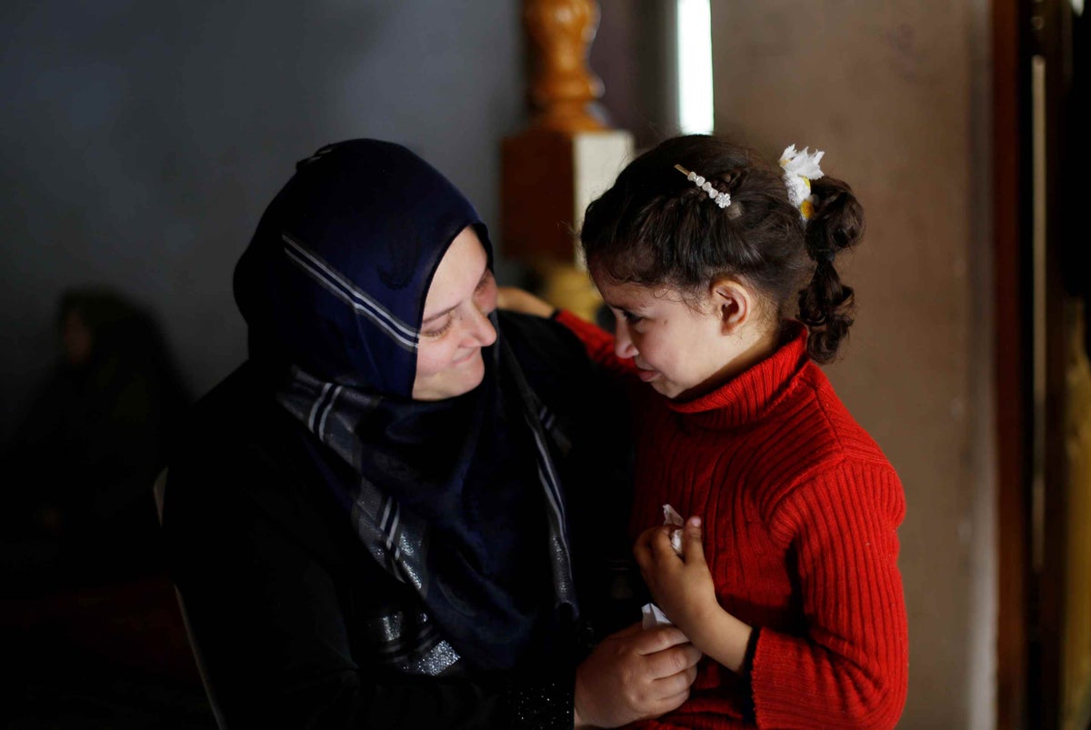 Neveen Barakat comforts her 6 year-old daughter Rosol in Beit Lahia in the northern Gaza Strip