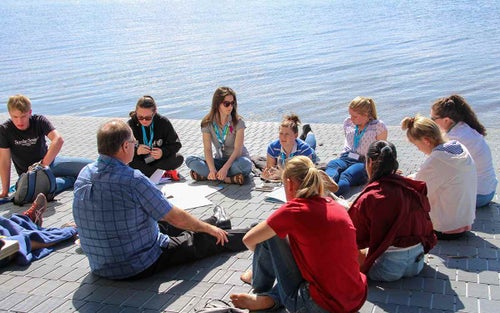 A group of teenagers sitting in a circle in a deep discussion