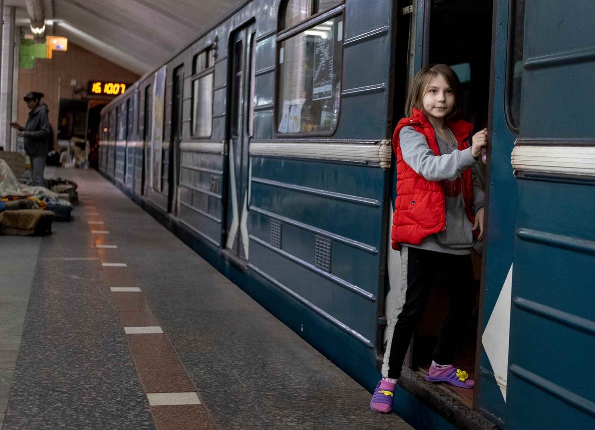 Olena stands at train doors