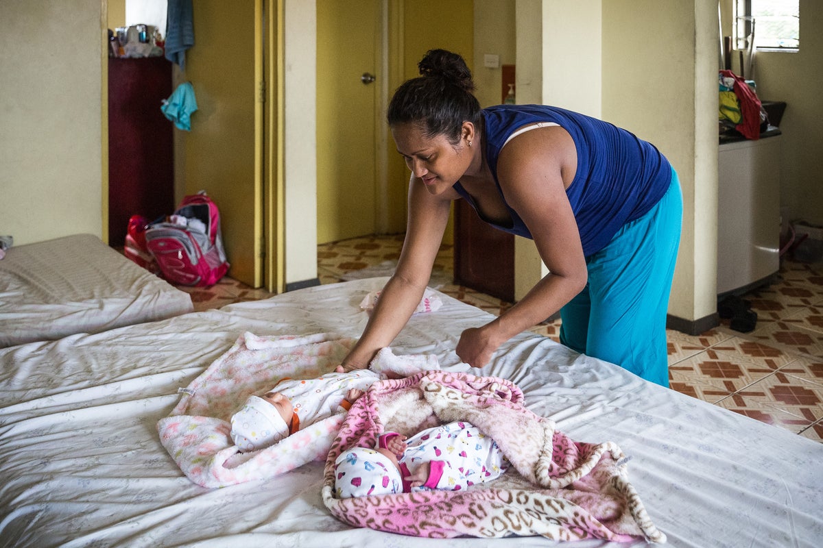 A mum is caring for her two newborn babies.