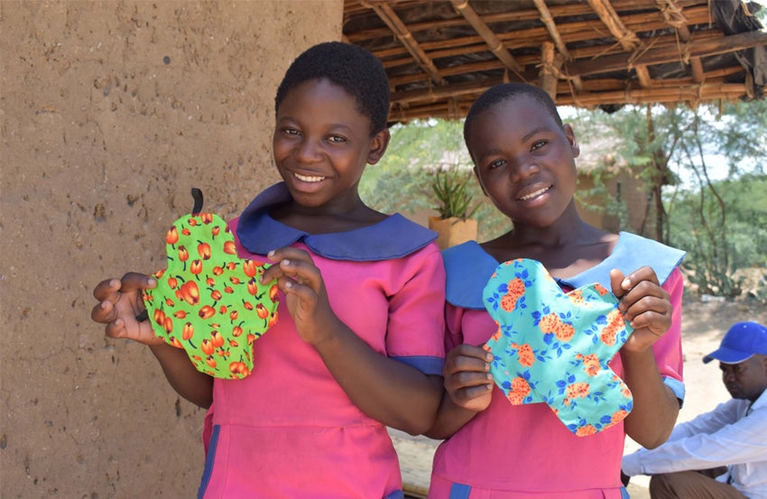 Two girls from Malawi make dignity pads 