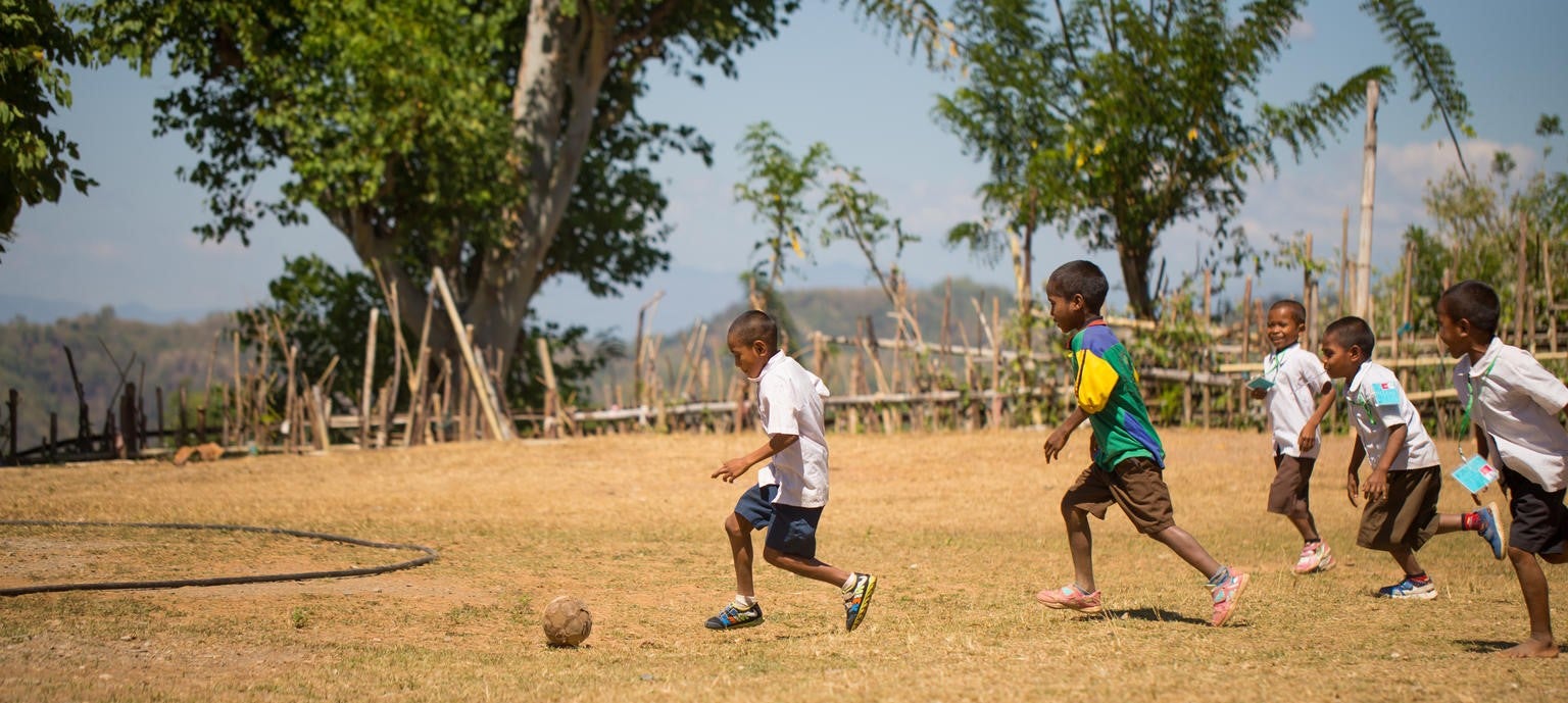 A group of Timor-Leste boys playing soccer.