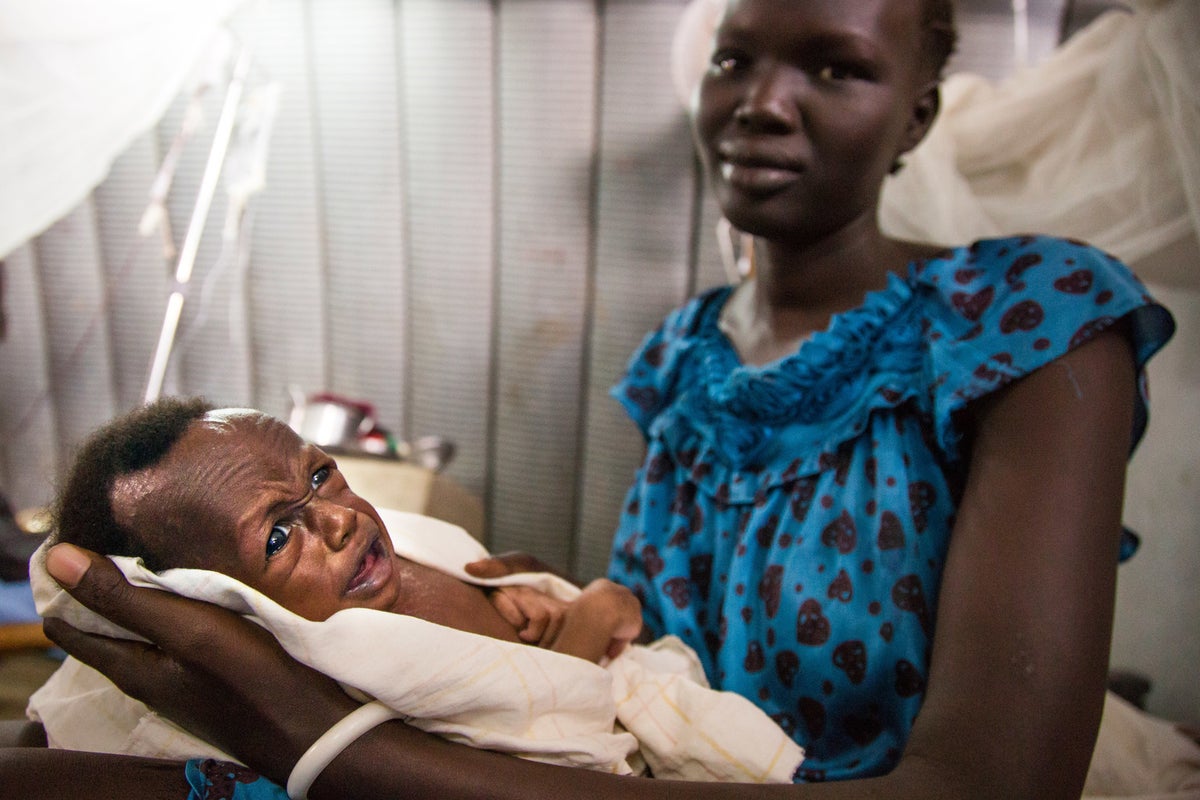 Mother holds her baby in a clinic in South Sudan