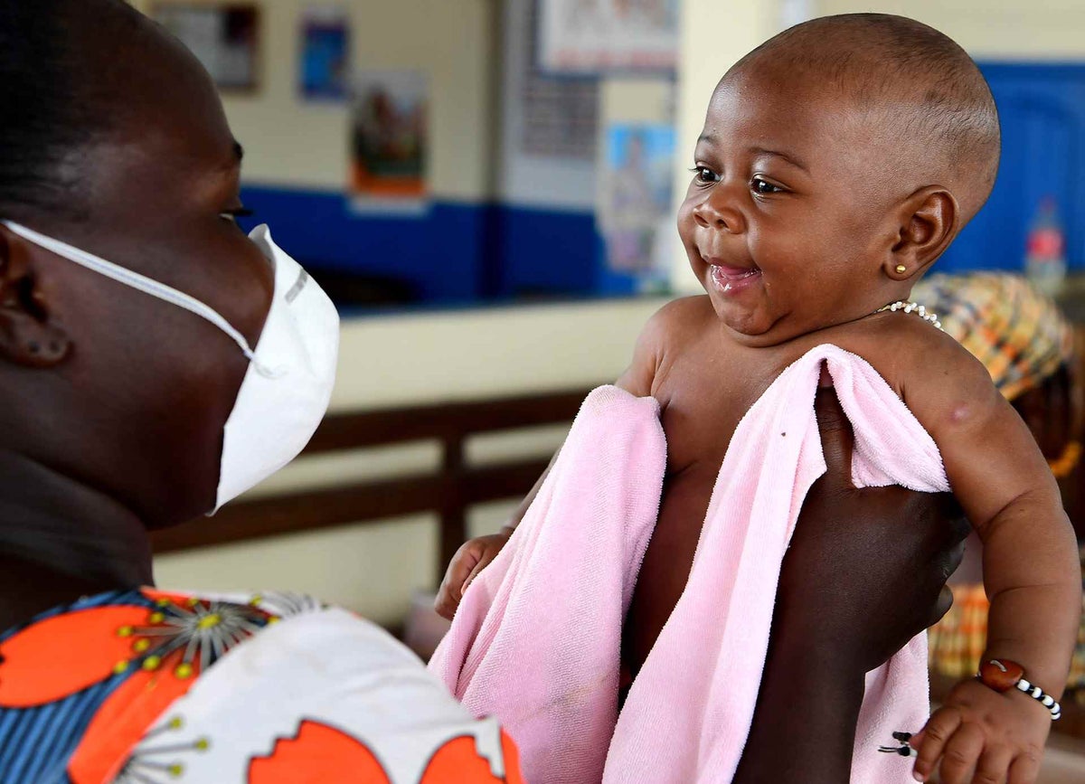 Christelle, 3 months old, is waiting to be weighted and vaccinated in the health center in the South of Côte d'Ivoire