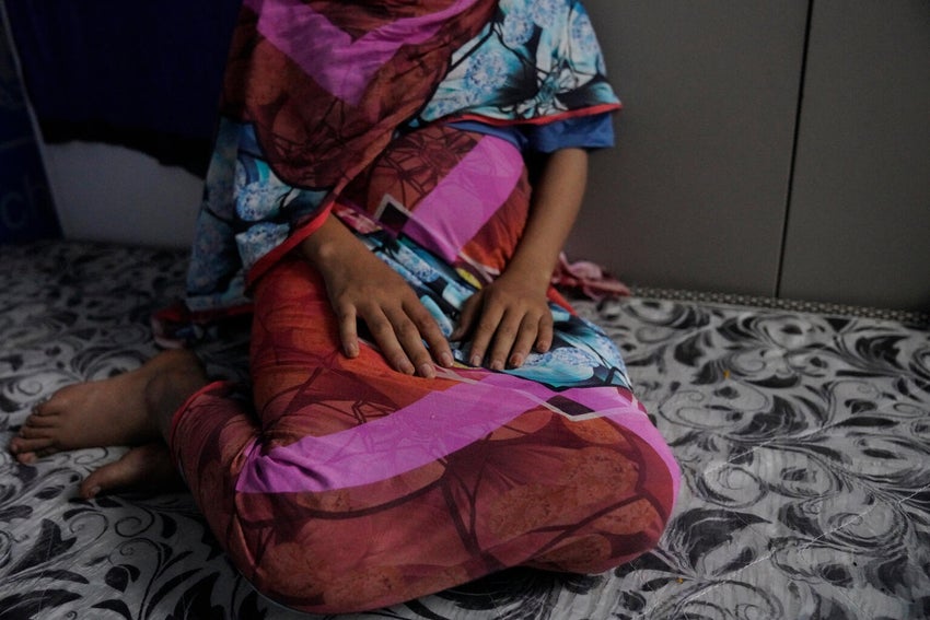 A 16-year-old girl recovering from gender-based-violence rests in a UNICEF office. 