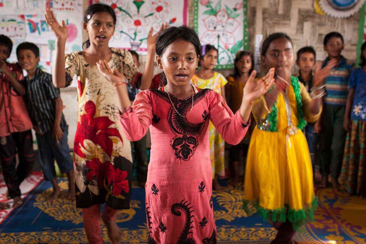 10-year-old Sehera and her friends lead a welcoming song at a nearby learning centre for children.