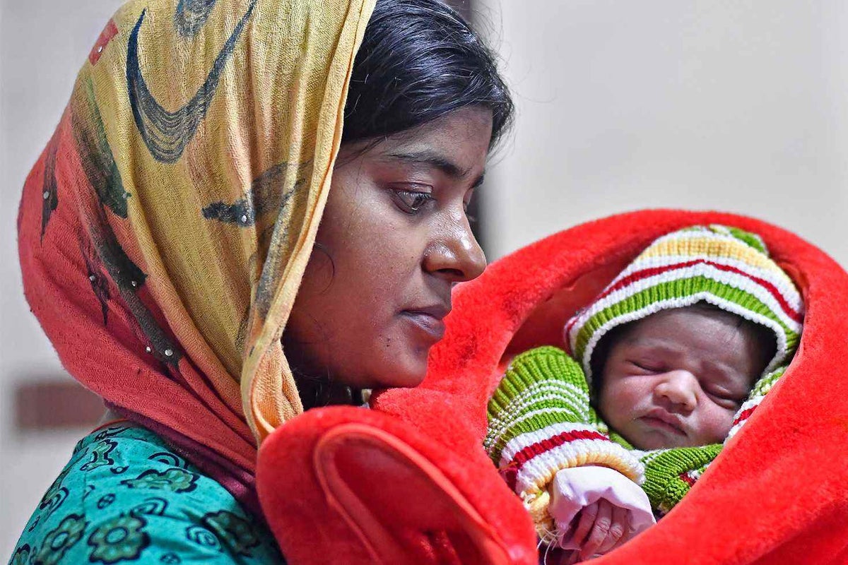 Kavita, 30, with her newborn baby at the Lady Harding Medical College in New Delhi.