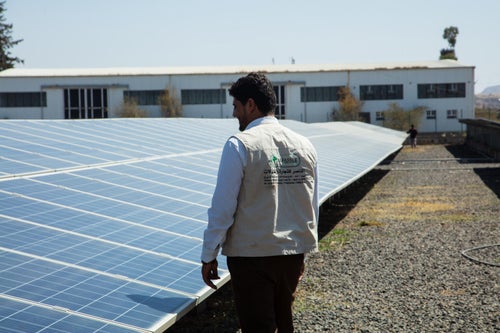 A local engineer in Yemen inspects the local solar farm