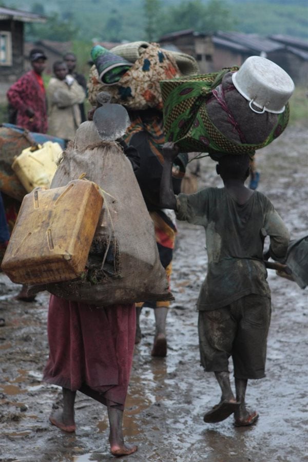 Displaced people enter the town of Kalembe, in North Kivu Province in the Democratic Republic of the Congo after fleeing their homes in the nearby town of Piti