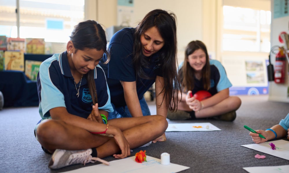 A young female student and a female occupational clinican smiling and in discussion. 