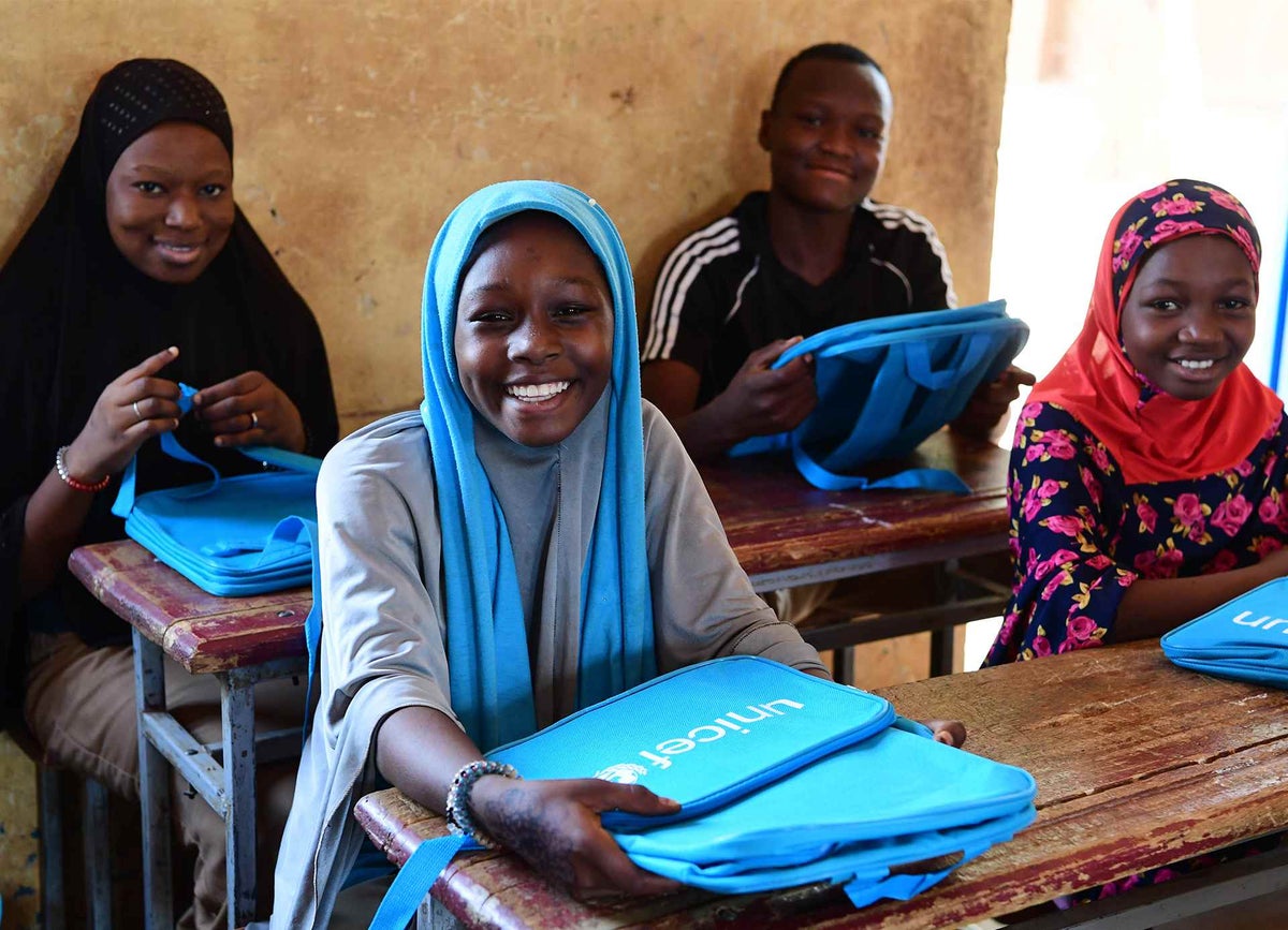 Children are very excited because they received UNICEF school backpacks in a school in Niger.