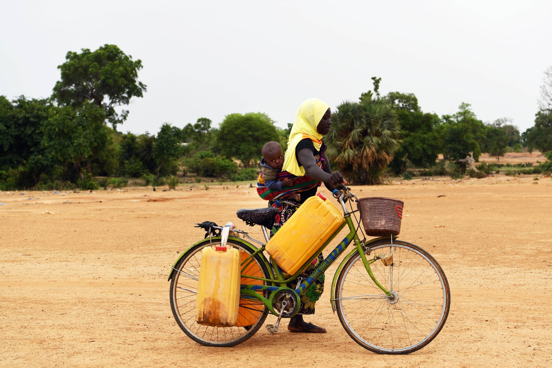 Mother and child on bike to collect water