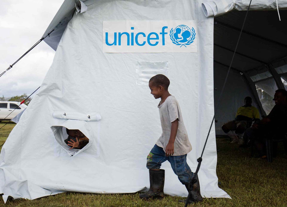 Children explore one of UNICEF’s new, high-performance tents, set up in Fiji to protect children after Tropical Cyclone Yasa. 